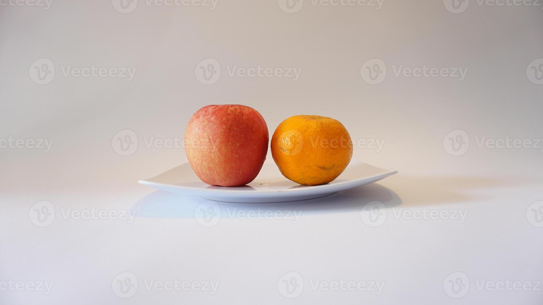 A white plate with two fruits on it photo