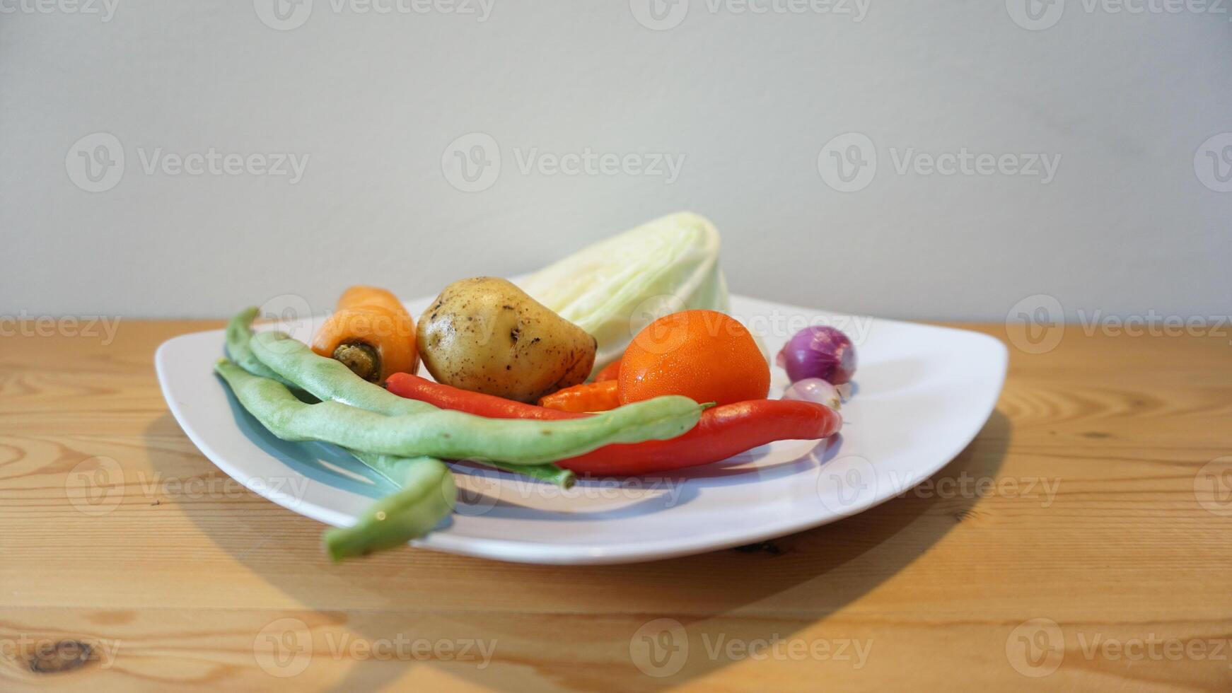 A white plate with vegetables on it photo