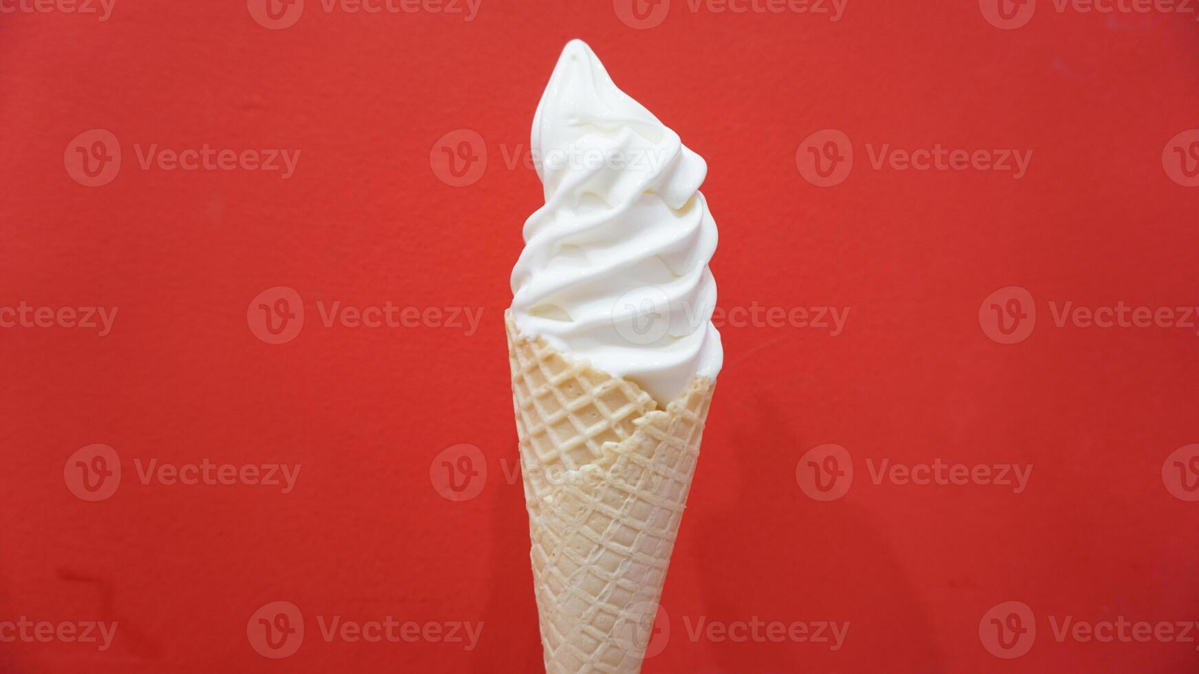 A cone of ice cream with a red background photo