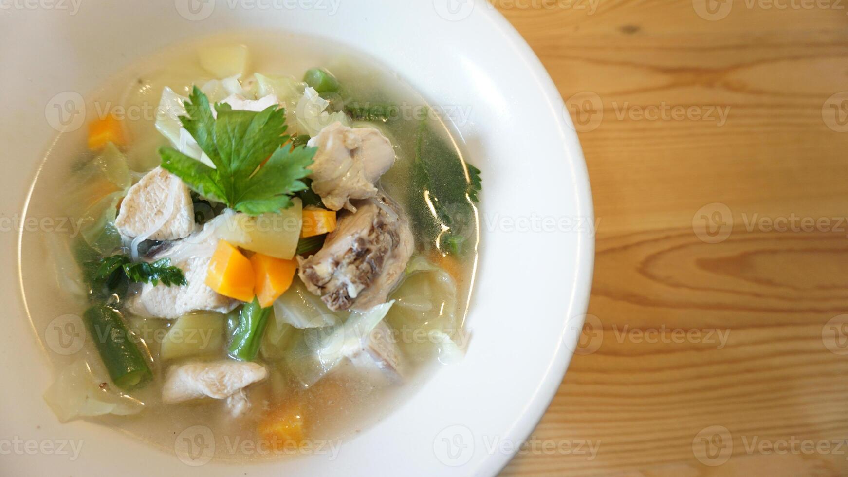 A bowl of soup with vegetables and meat photo