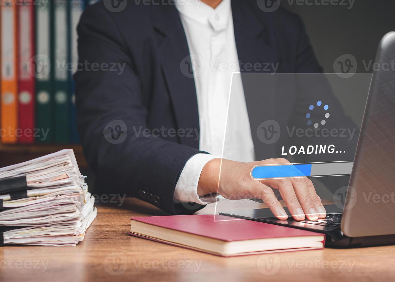 Businessman uses a laptop for loading and processing data on a virtual screen. Close-up. photo