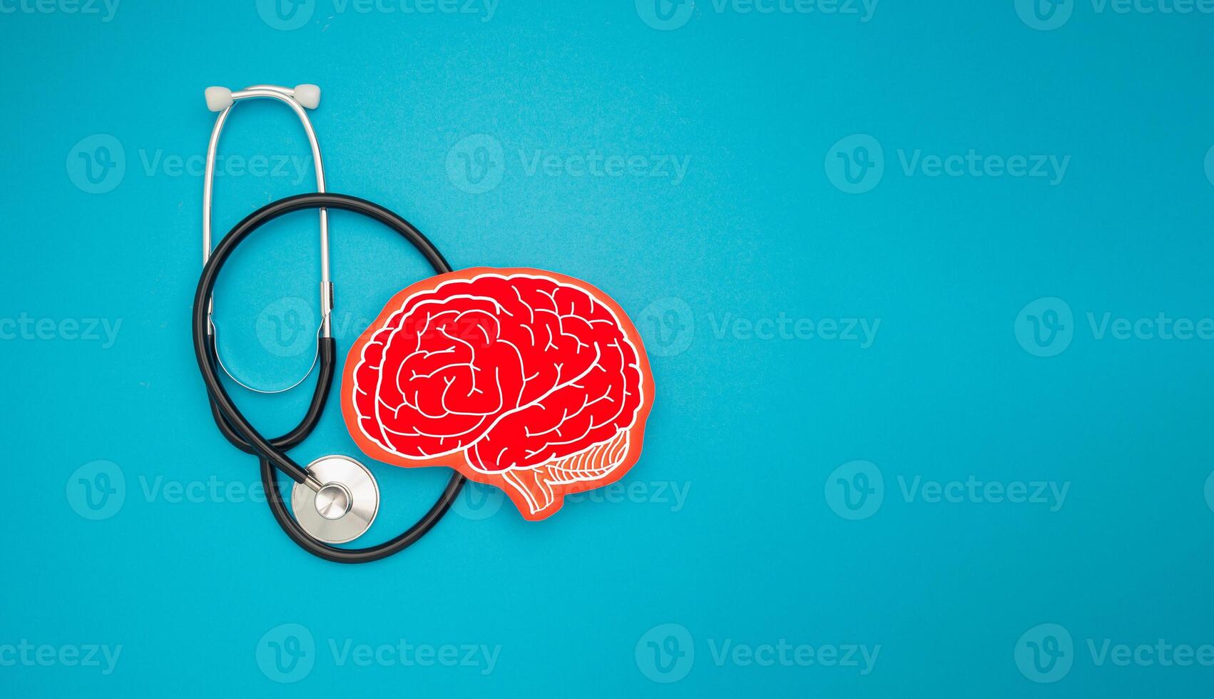 A brain shape symbol and a stethoscope on a blue background photo