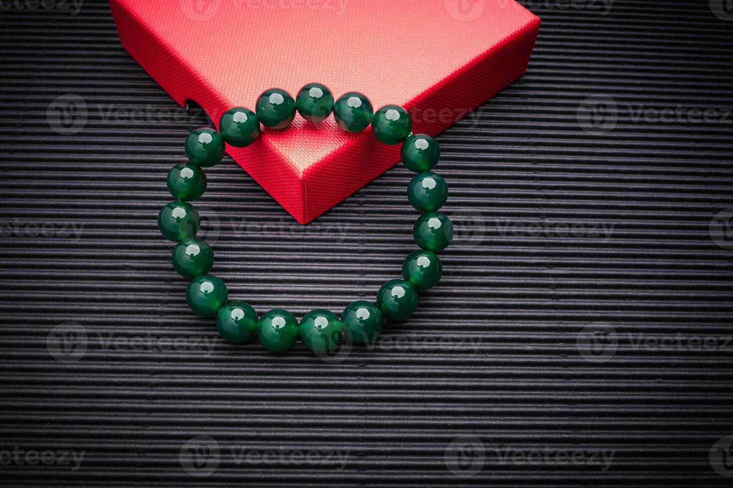 Jade bangle or bracelet on a black background. Top view photo