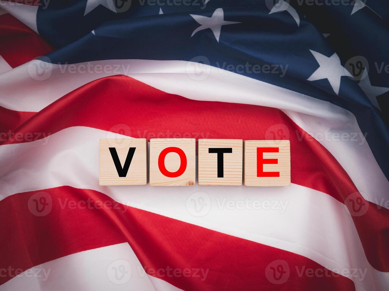Wooden cubes with letters VOTE over the American flag background. Top view. photo