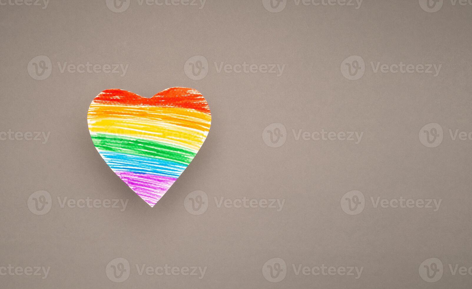 A rainbow heart made from paper on a gray background photo
