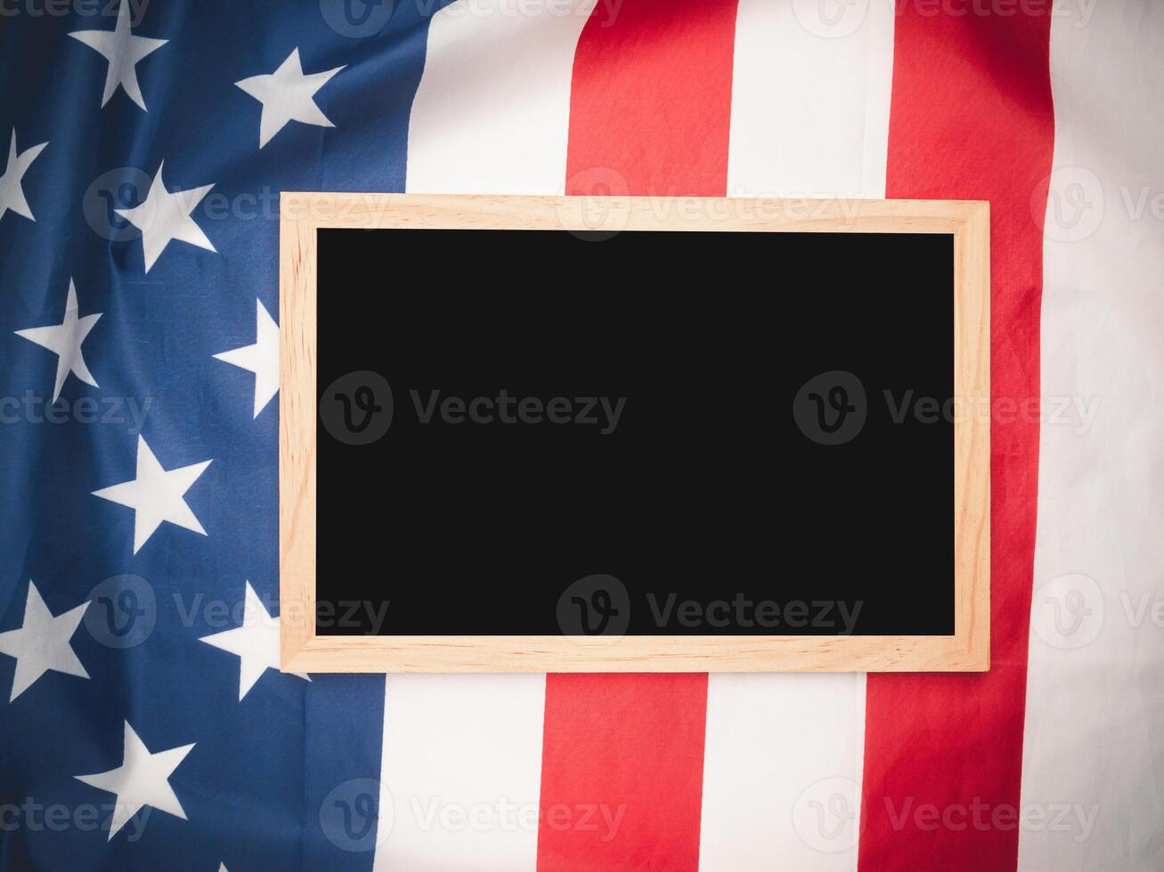 Top view of a mini chalkboard over the American flag background. photo