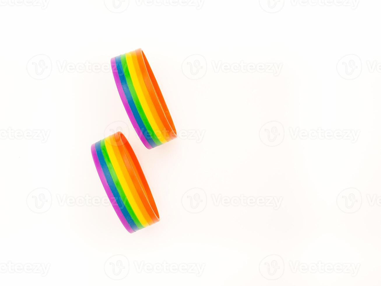 Rainbow patterned wristbands are on a white background. photo
