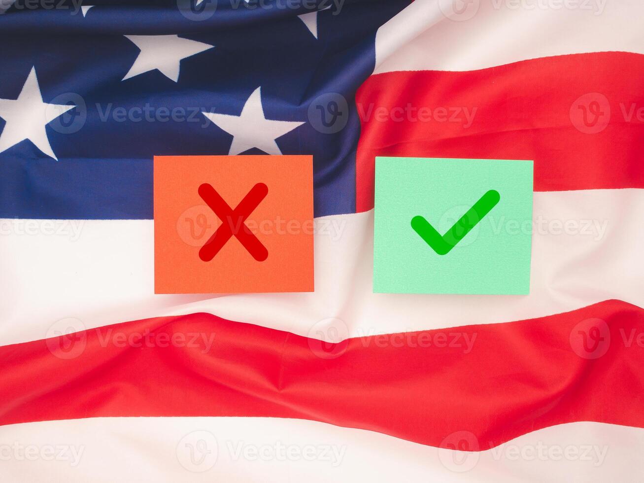 Two paper with a green checkmark and a red cross on the American flag background photo