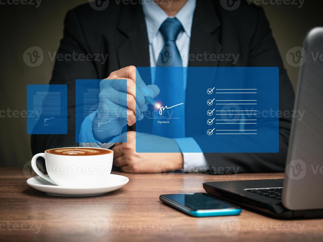 Close-up of a businessman uses a pen to sign electronic documents on a virtual screen while sitting at the table photo