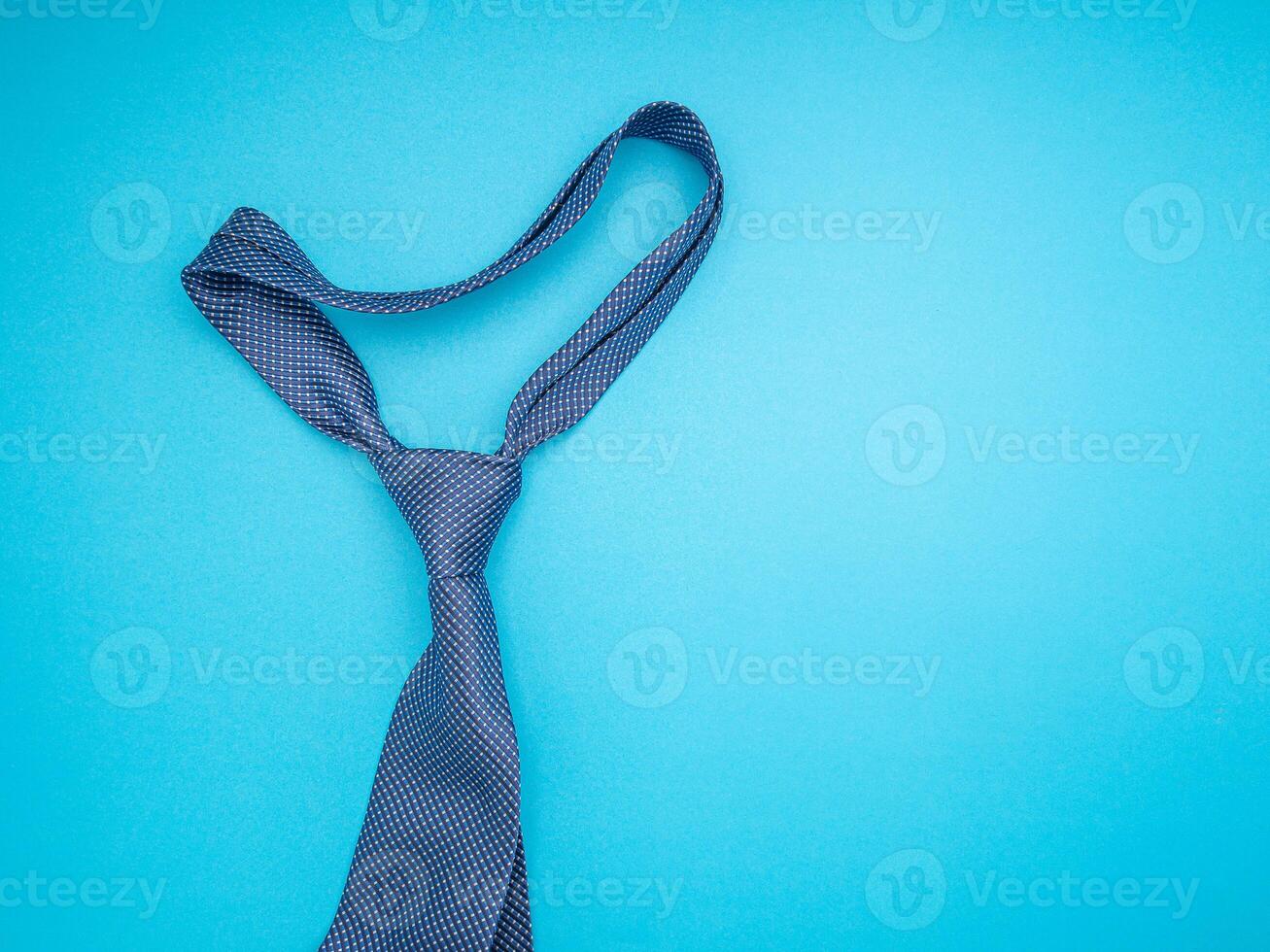 Top view of a necktie on a blue background photo