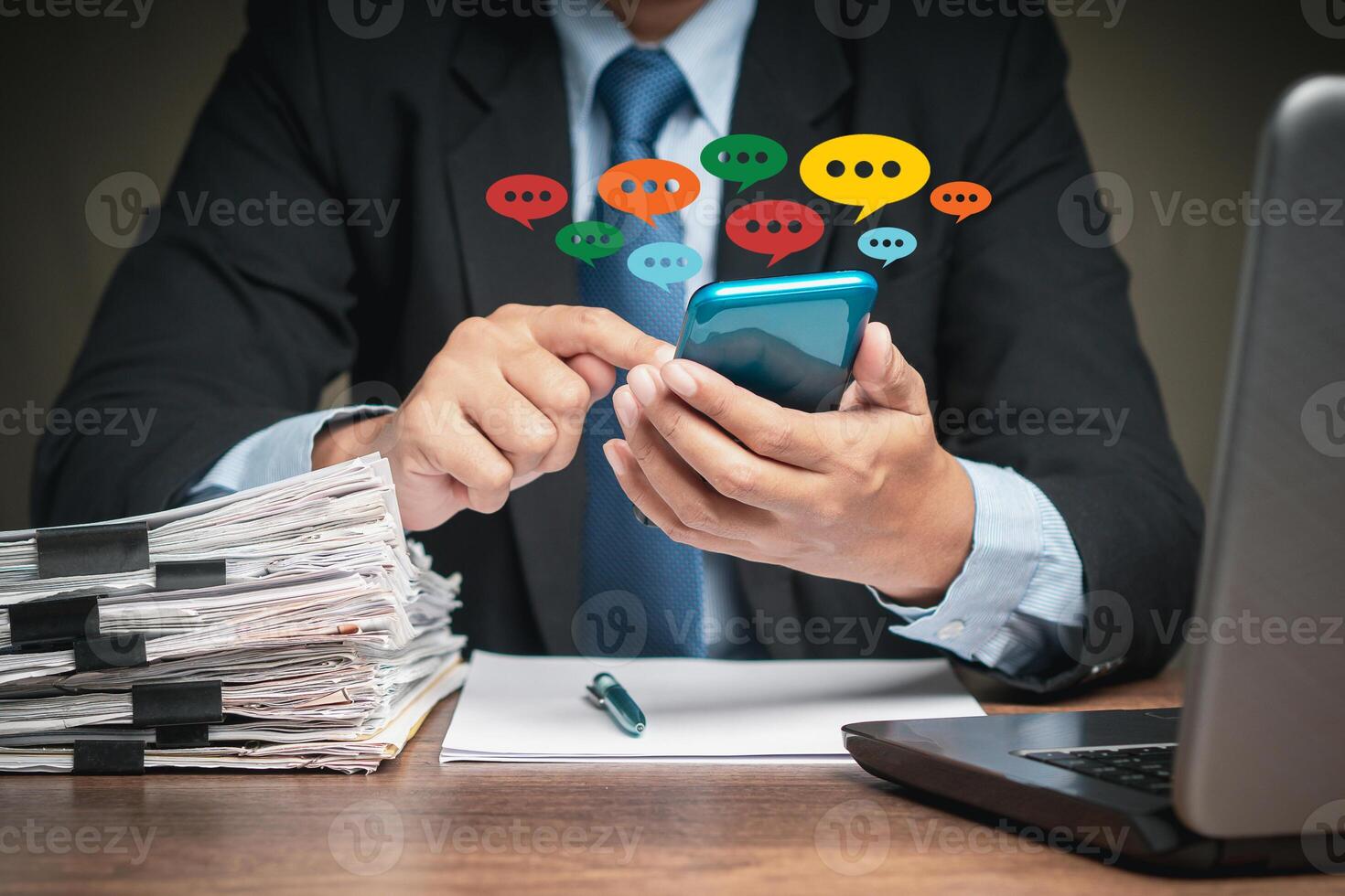 Businessman in a suit using a smartphone while sitting at the table photo