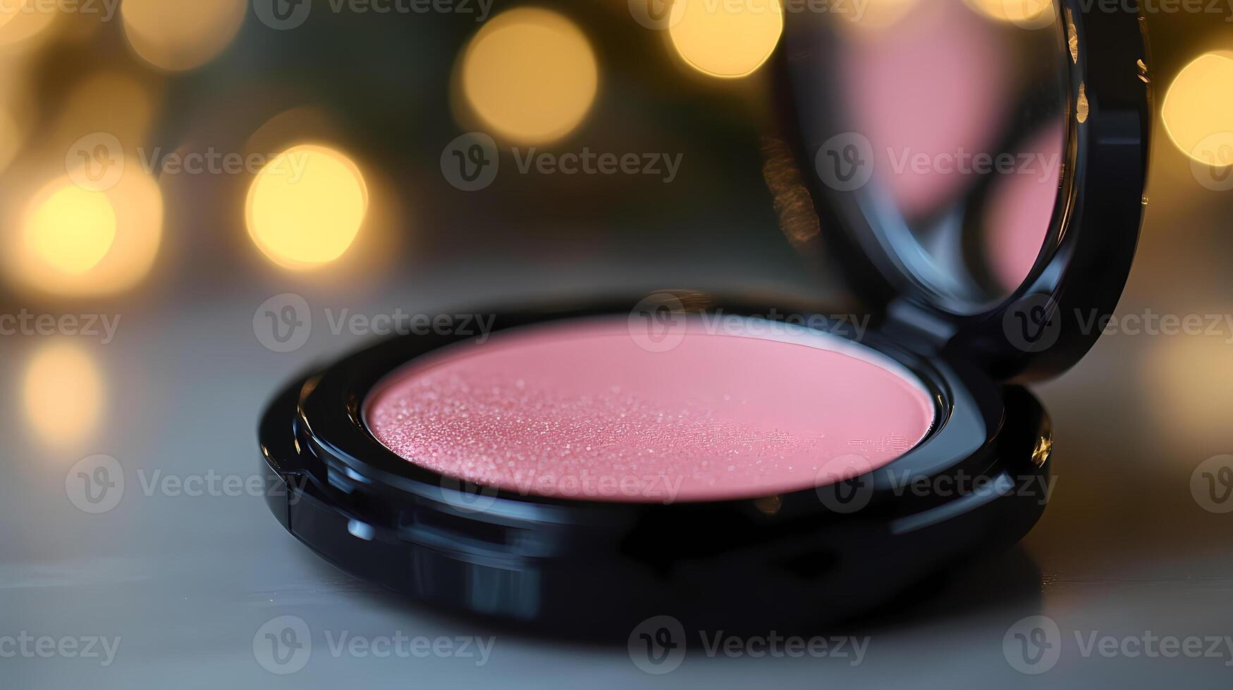 Pink powder blush palette with warm christmas lights reflecting in the mirror photo