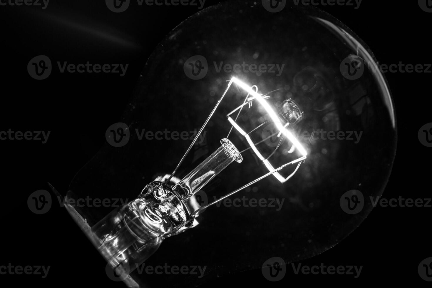 Close-up of electrical bulb on black background photo