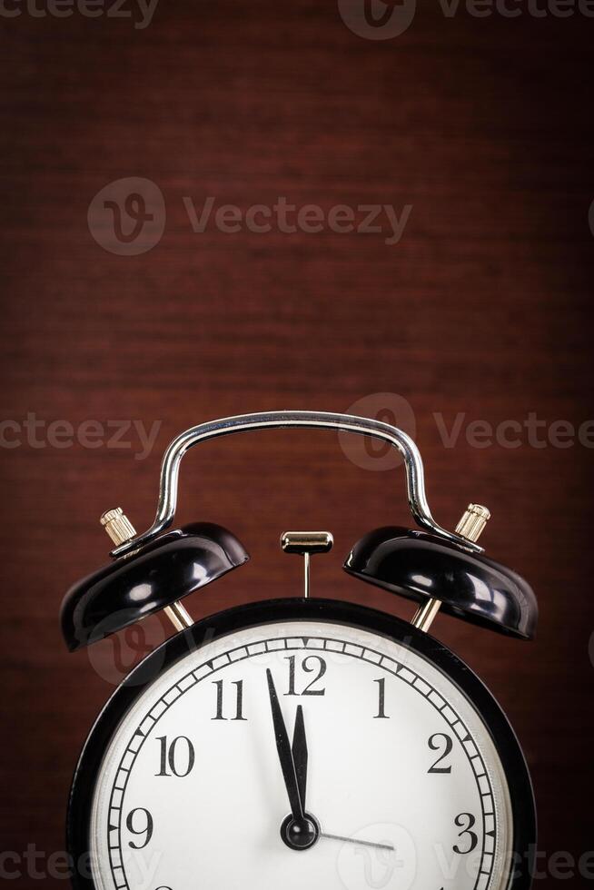 Close up of a black old-fashioned alarm clock photo