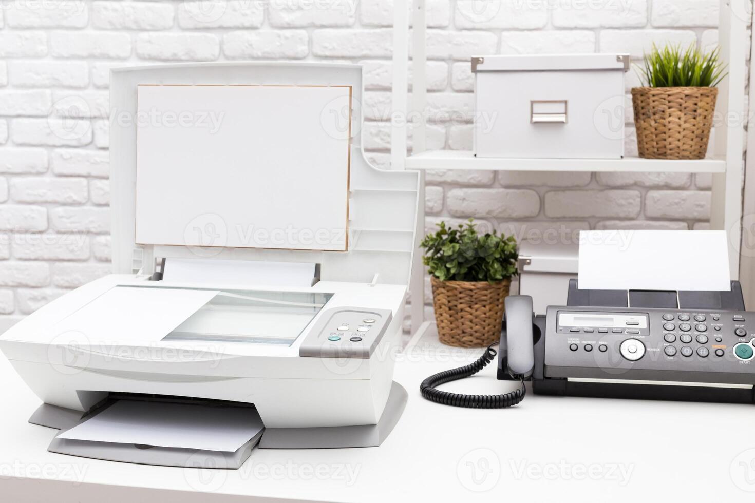 Printer and fax machine on office table photo