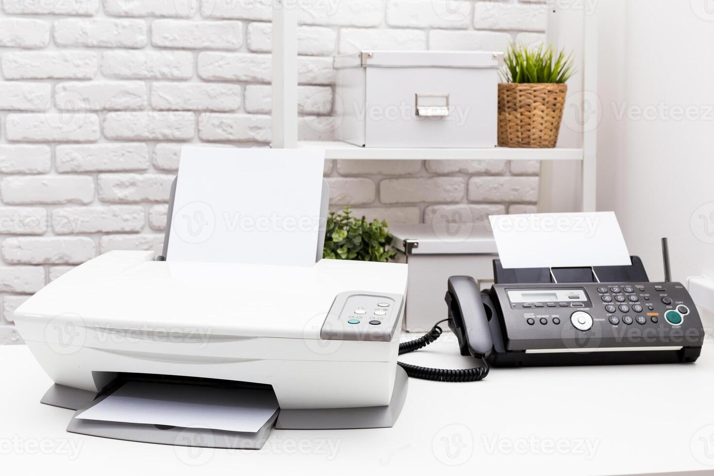 Printer and fax machine on office table photo