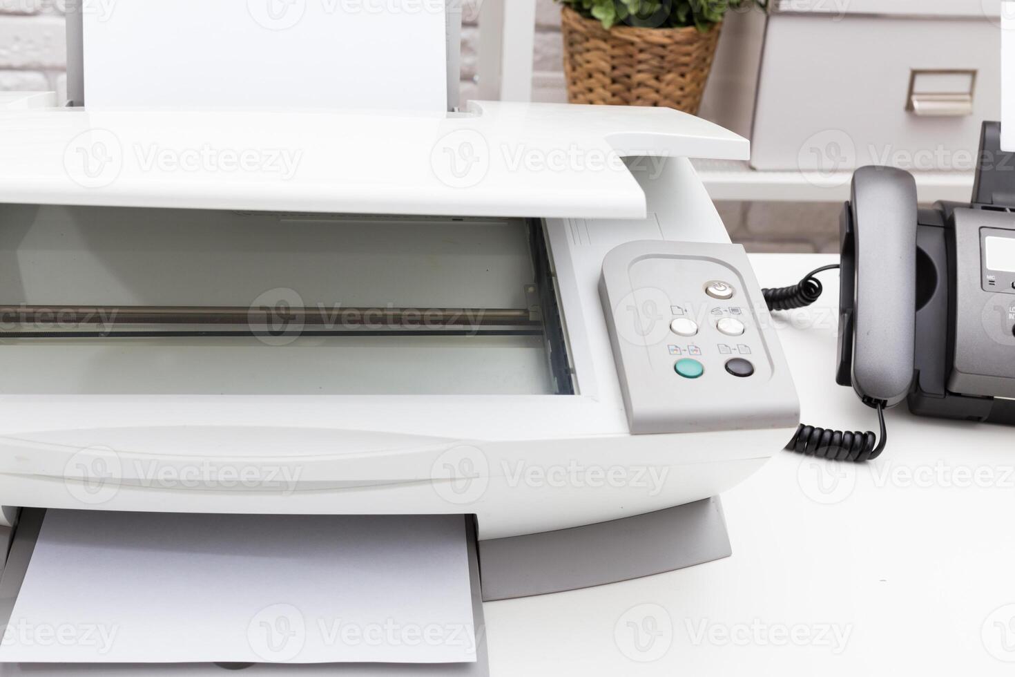 Printer and fax machine on office table photo