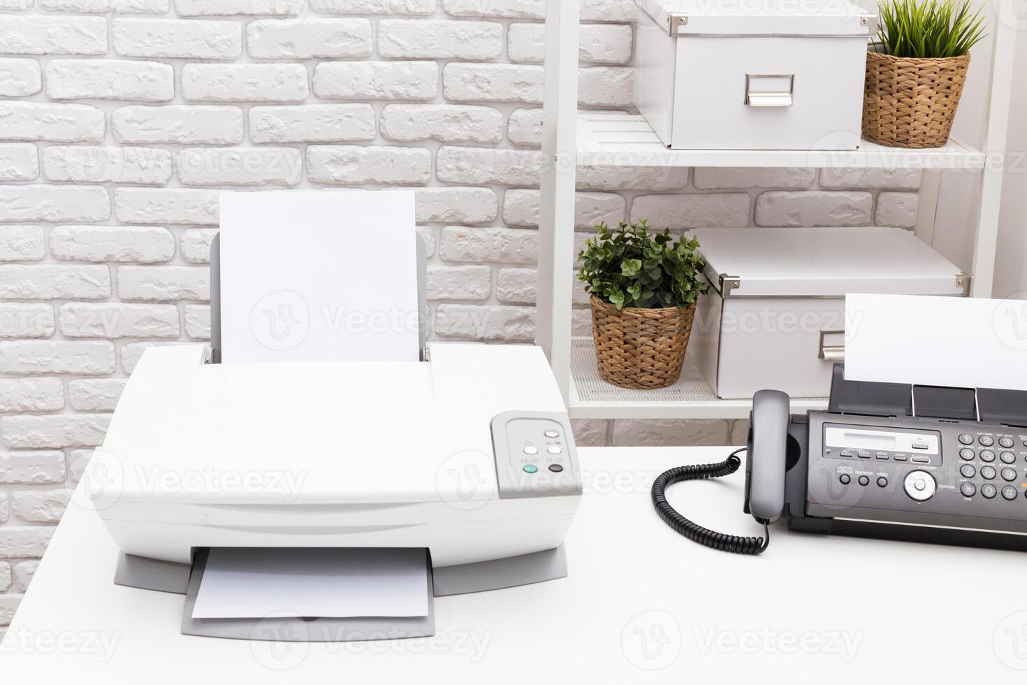 Printer and fax machine on office table photo