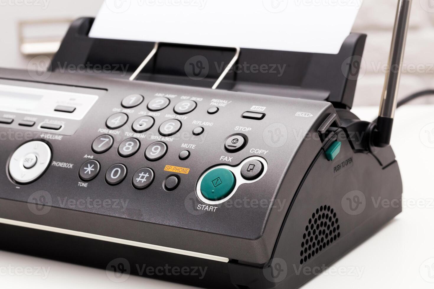 Close up of a fax machine in an office photo