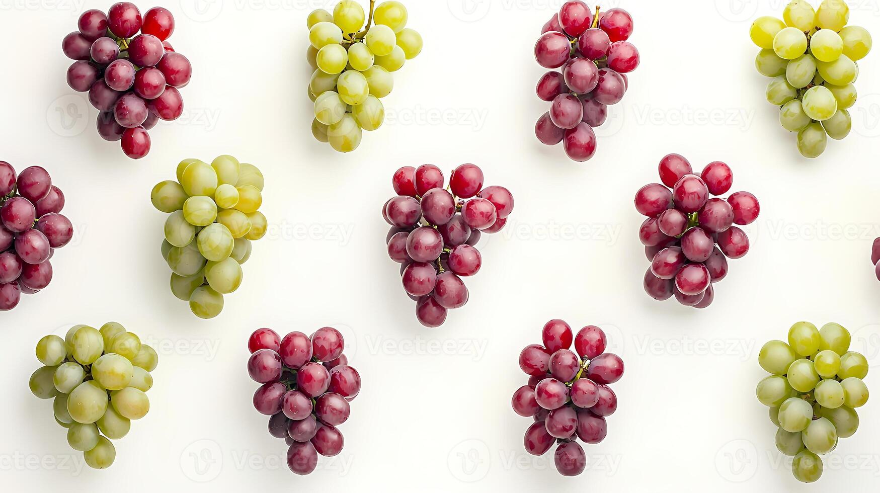 Bunches of green and red grapes forming a pattern on white background photo