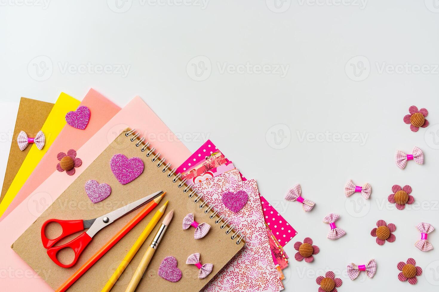 Crafting materials arranged for creative projects with colorful papers and decorative items photo