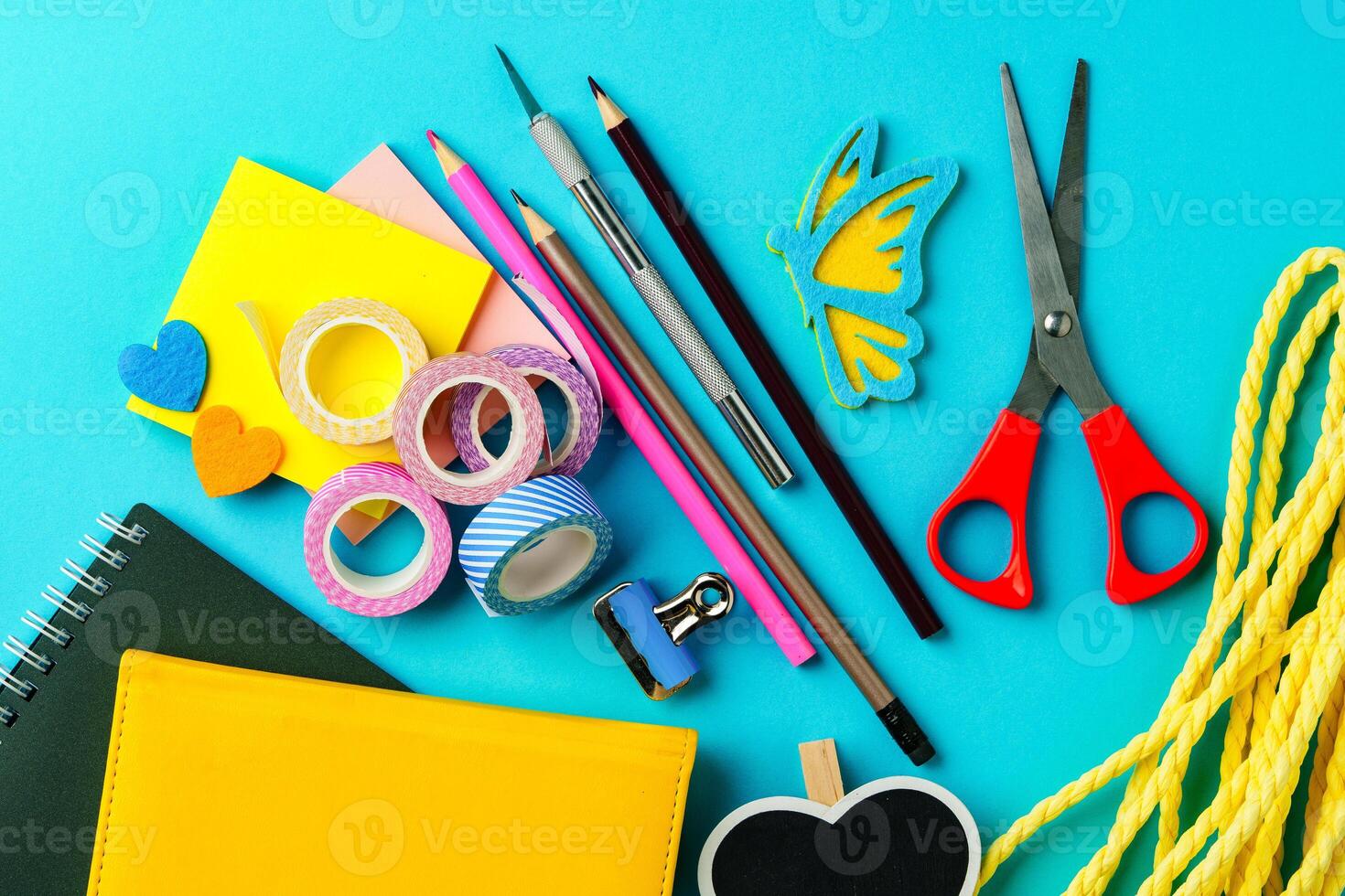 Craft supplies arranged on a vibrant blue background for creative projects and DIY activities photo