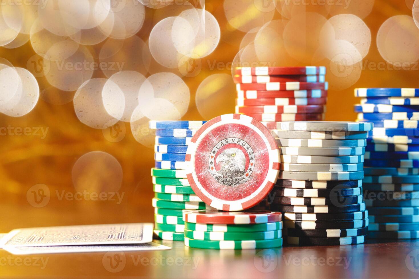 Poker chips stacks on bokeh light background photo
