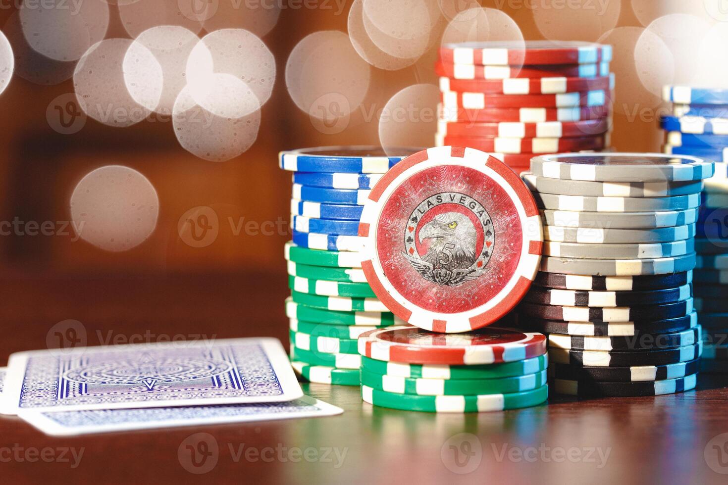 Poker chips stacks on bokeh light background photo