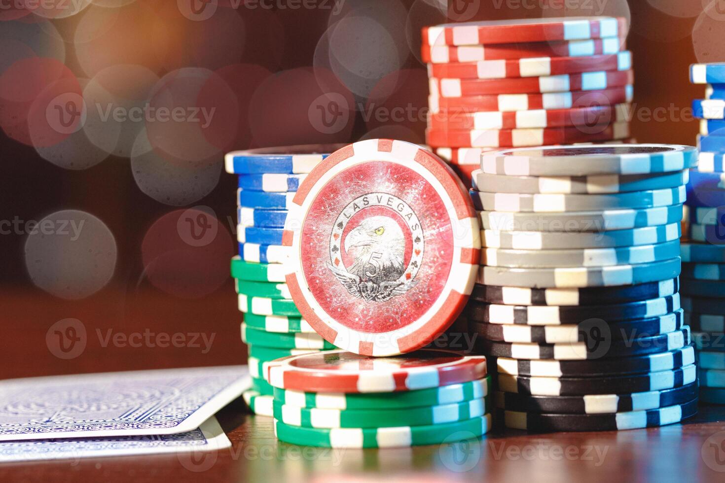 Poker chips stacks on bokeh light background photo