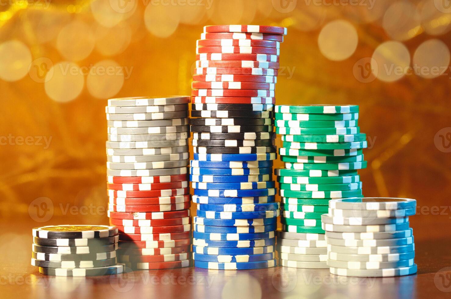 Poker chips stacks on bokeh light background photo