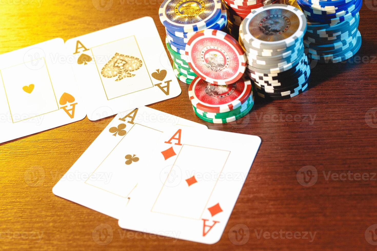 Poker cards and chips on blurred background photo