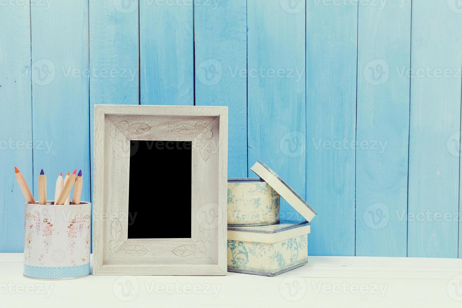 Wooden items of home decor close up on blue wooden background photo