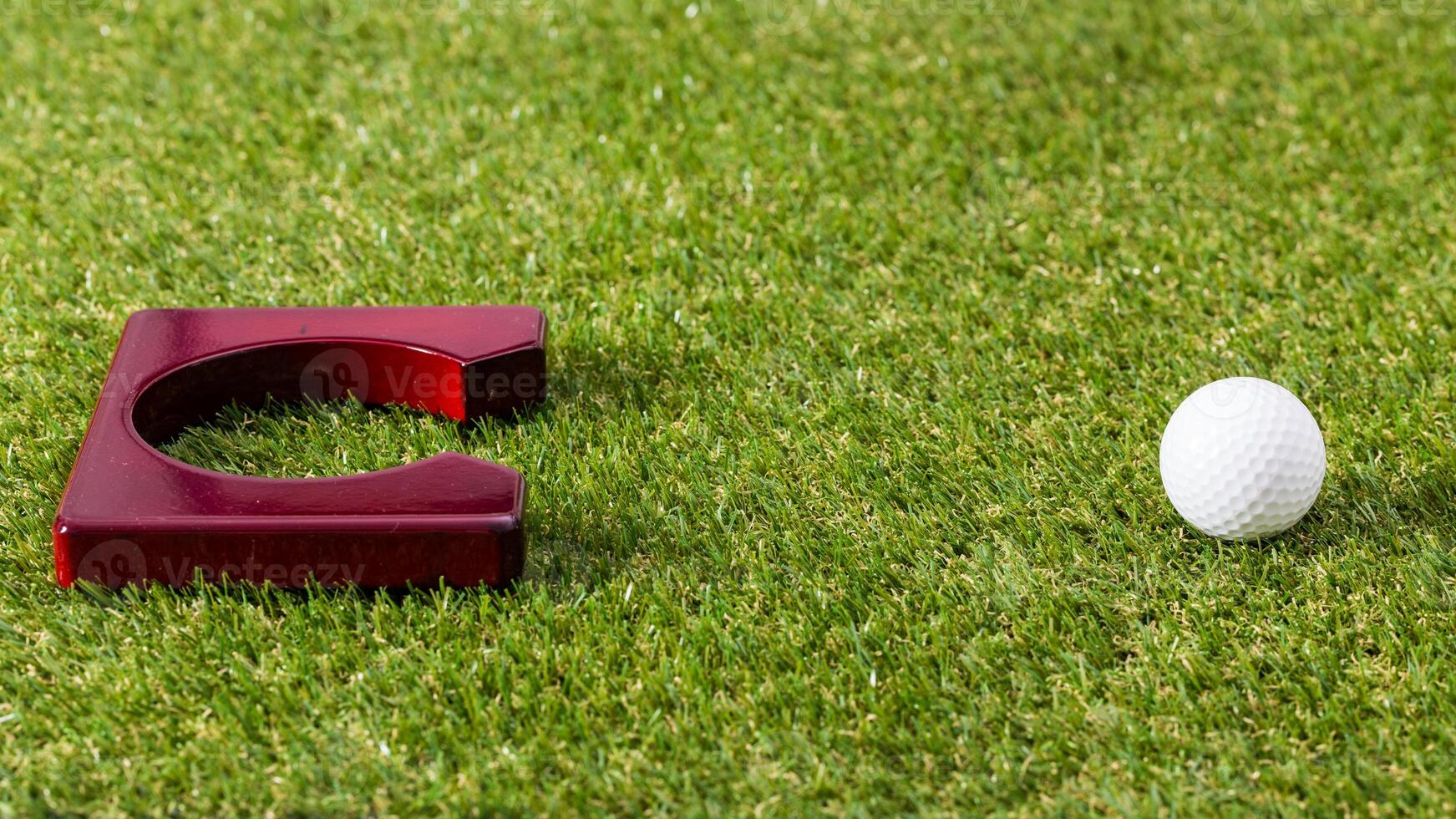 Mini golf. Golf equipment on grass close up photo