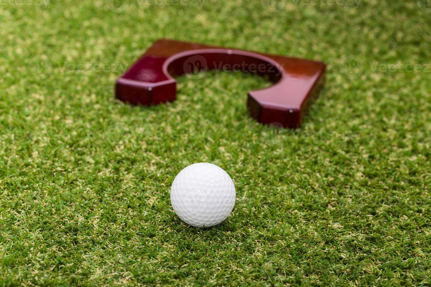 Indoor mini golf equipment set on green grass background photo