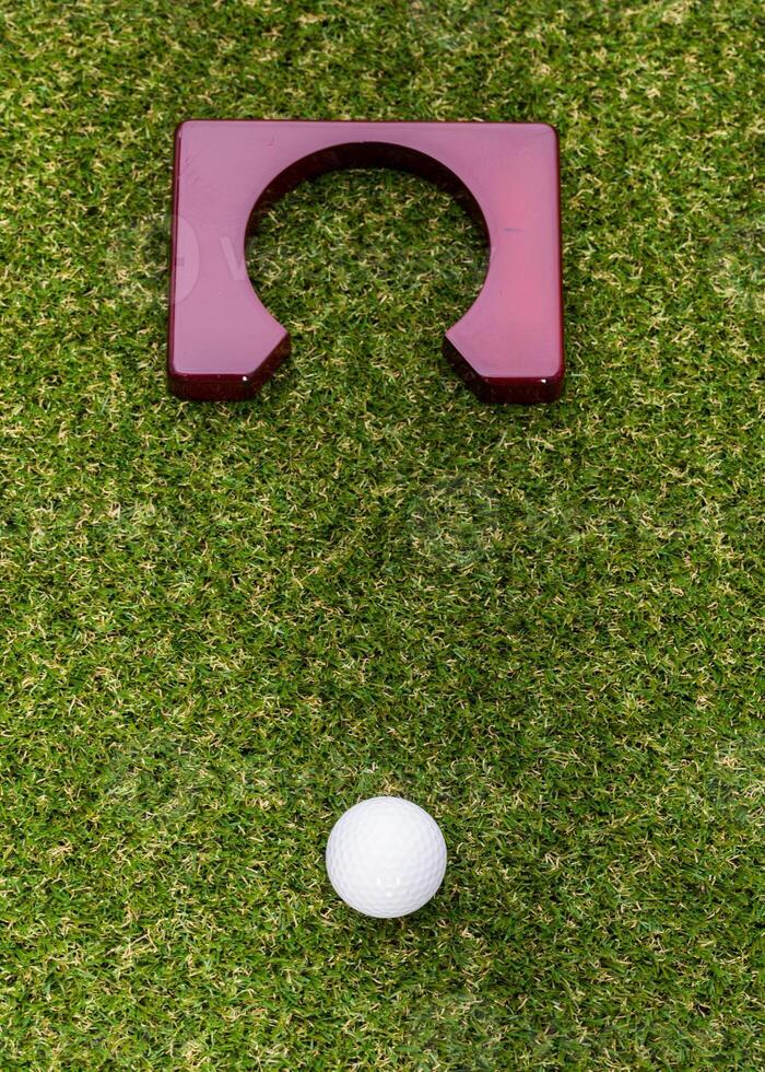 Indoor mini golf equipment set on green grass background photo
