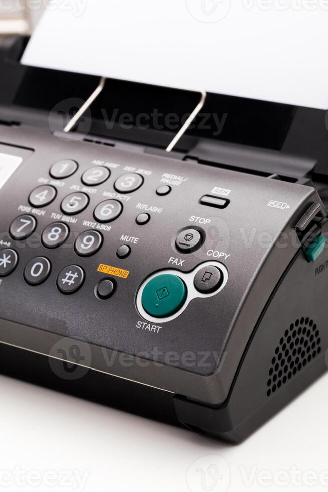 Close up of a fax machine in an office photo