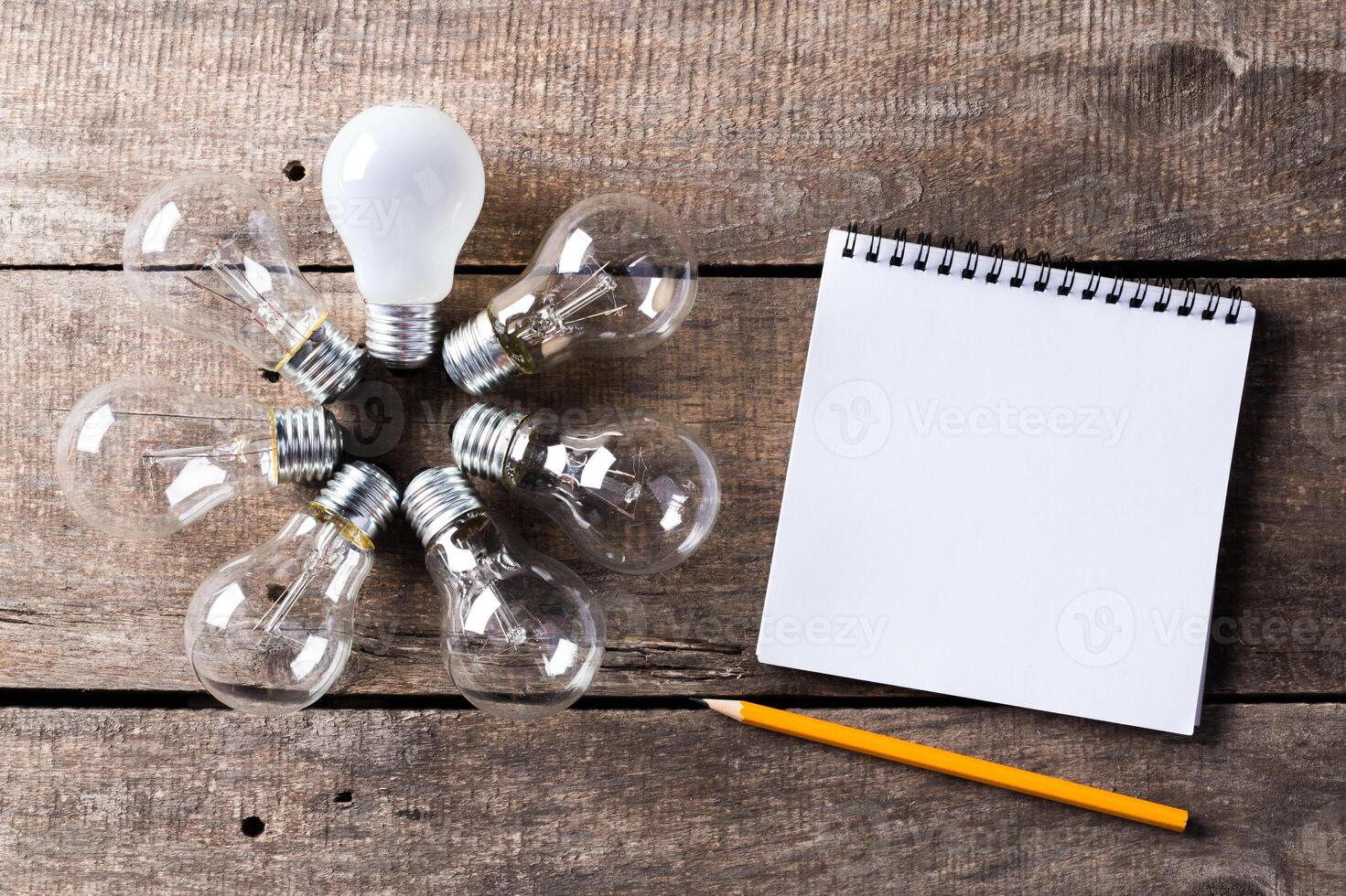 Lightbulb and blank open notepad. Having an idea concept photo