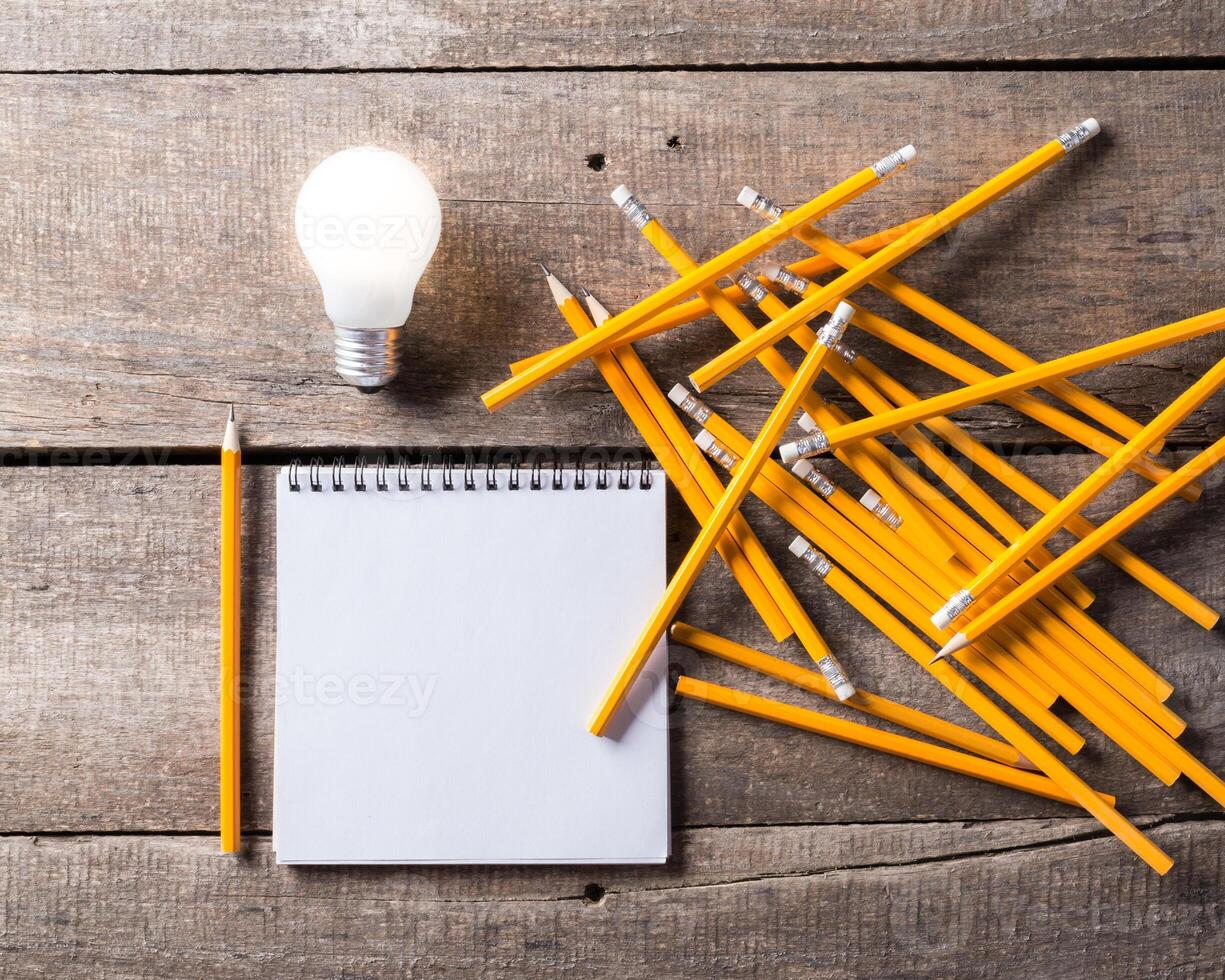 Lightbulb and blank open notepad. Having an idea concept photo