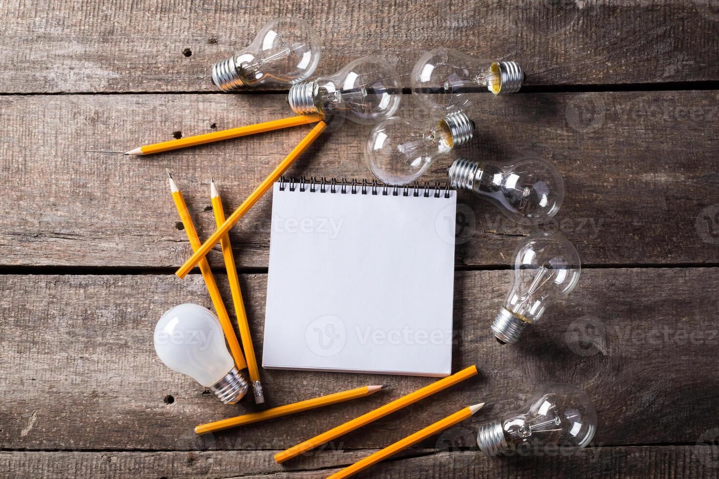 Lightbulb and blank open notepad. Having an idea concept photo