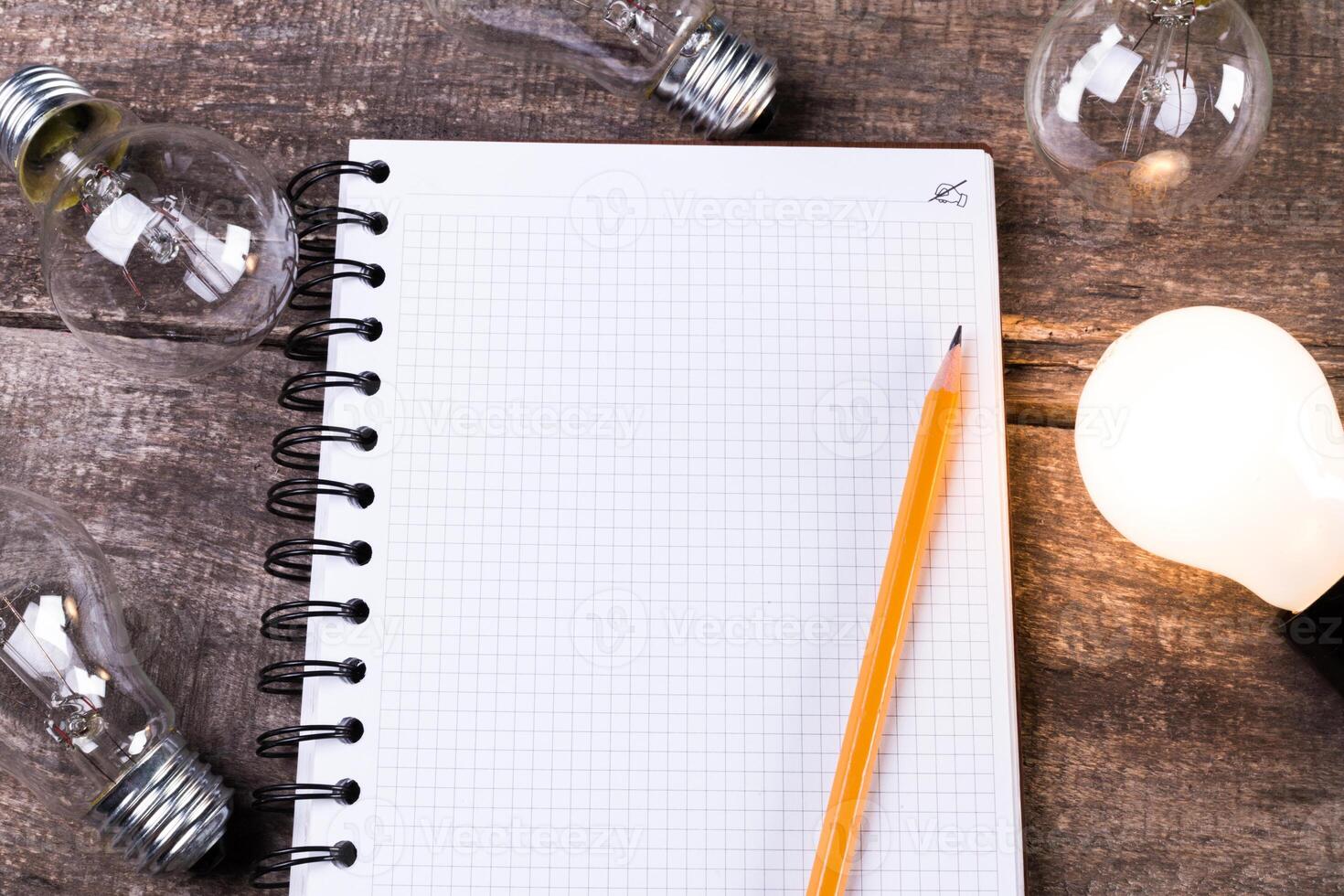 Lightbulb and blank open notepad. Having an idea concept photo