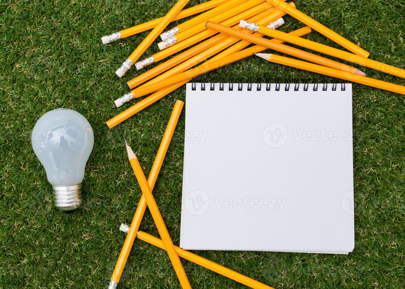 Lightbulb and blank open notepad. Having an idea concept photo