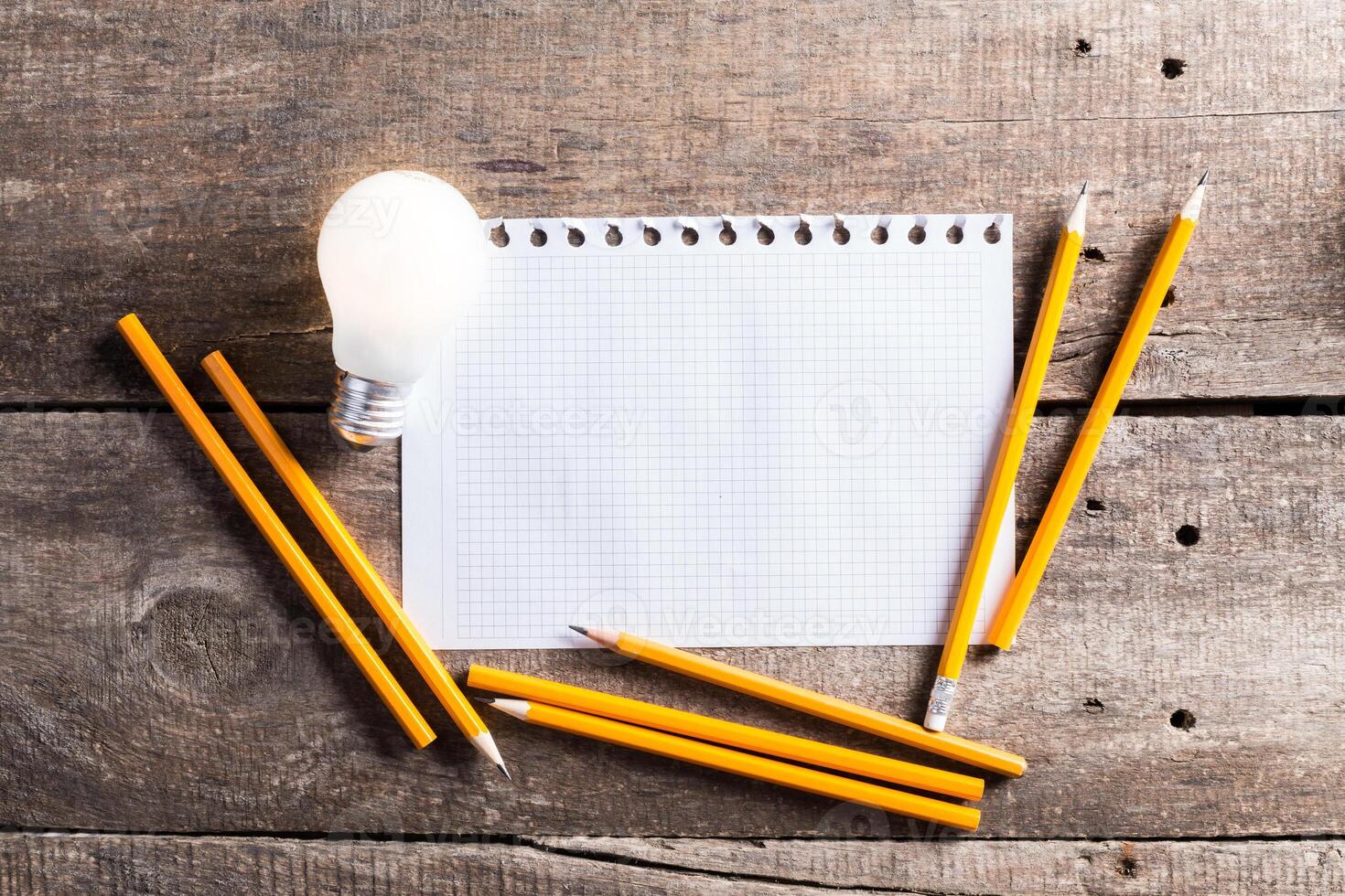 Lightbulb and blank open notepad. Having an idea concept photo
