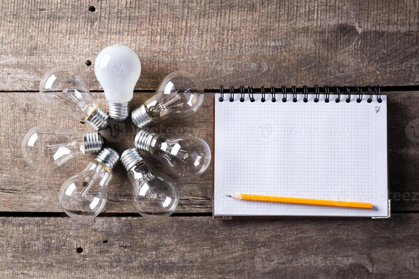 Lightbulb and blank open notepad. Having an idea concept photo