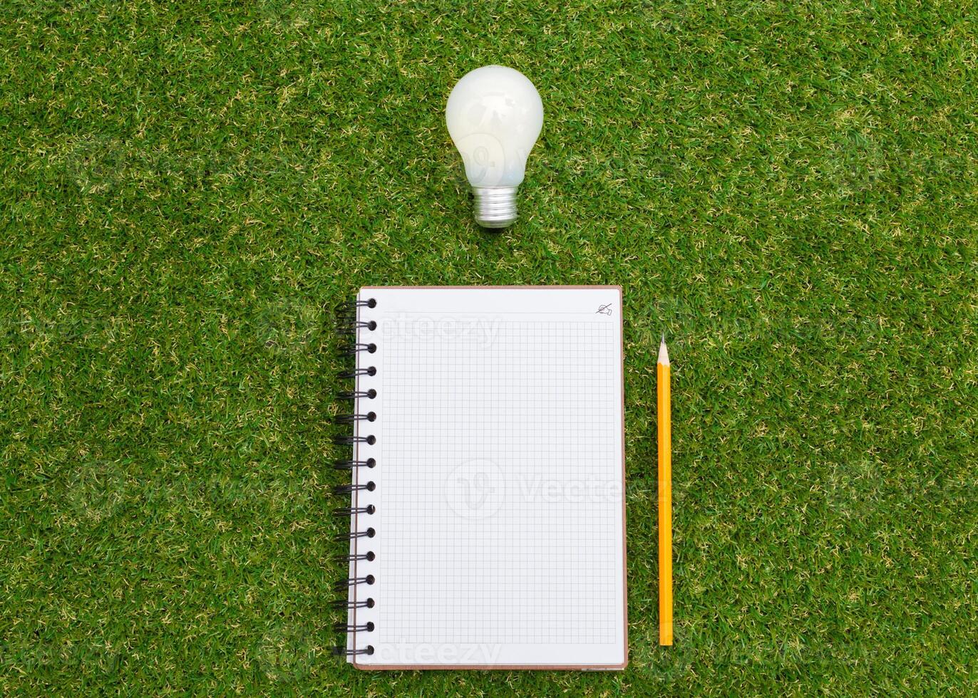 Lightbulb and blank open notepad. Having an idea concept photo