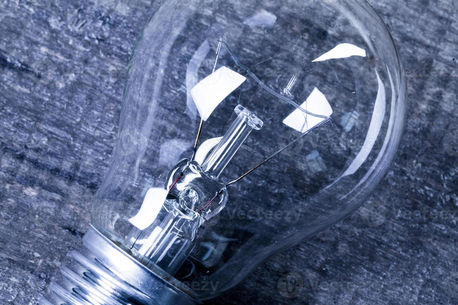Electrical light bulb over wooden background close up photo