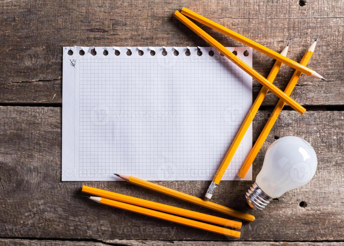 Lightbulb and blank open notepad. Having an idea concept photo