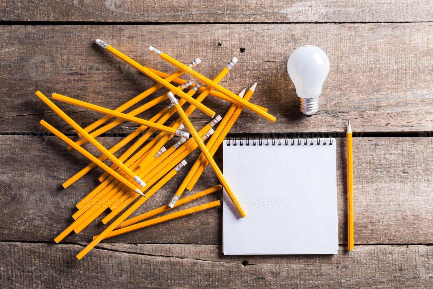 Lightbulb and blank open notepad. Having an idea concept photo