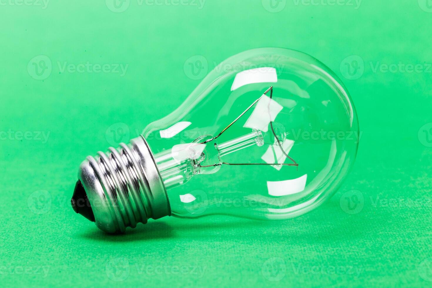 light bulb on green background close up photo