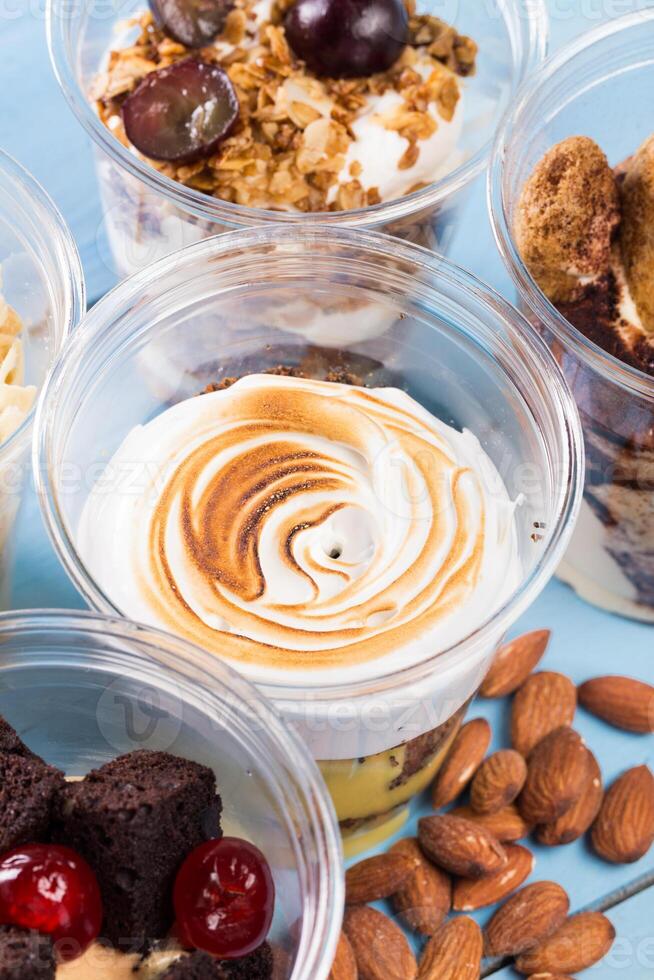Close up of several desserts in cups photo
