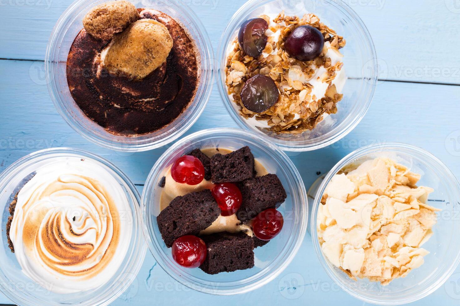 Close up of several desserts in cups photo